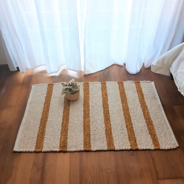 small handwoven cream and yellow rug