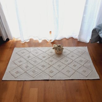 small beige knotted rug