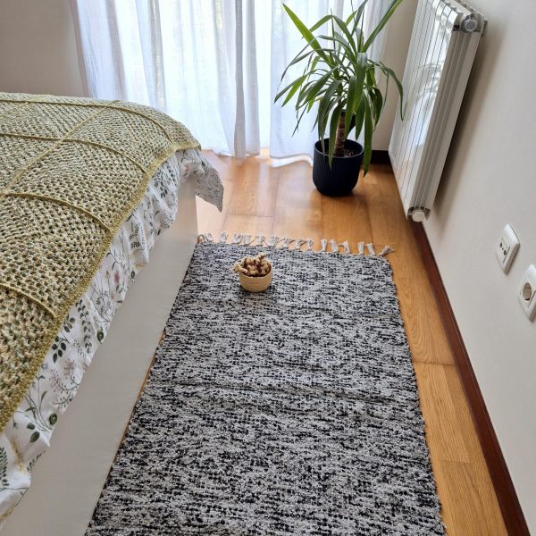 medium rug with black and grey spots