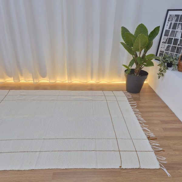 cream rug with mustard yellow lines